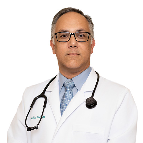A headshot of Dr. Delfin Fuentes, M.D. He is wearing a white coat over a blue shirt and tie. He has a stethoscope around his neck.