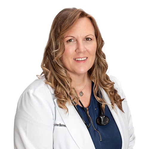 A headshot of Catherine Bennett, APRN. She is wearing a blue shirt, white coat, and has a stethoscope around her neck.