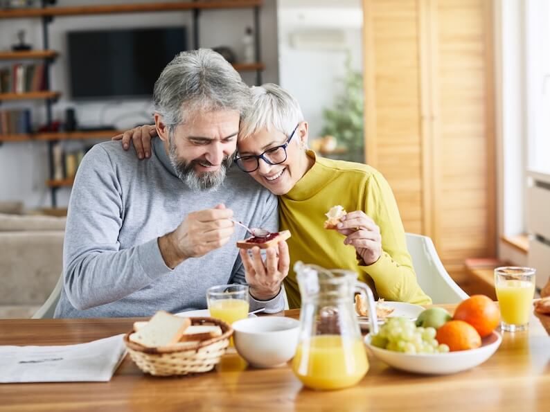 Senior couple eating breakfast as part of a healthy lifestyle.