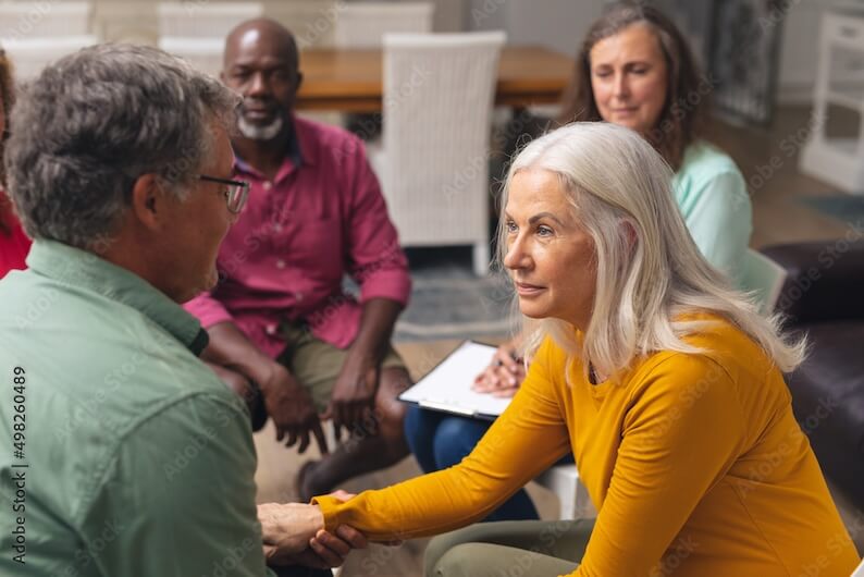 Senior woman in support group for those living with Parkinson's Disease