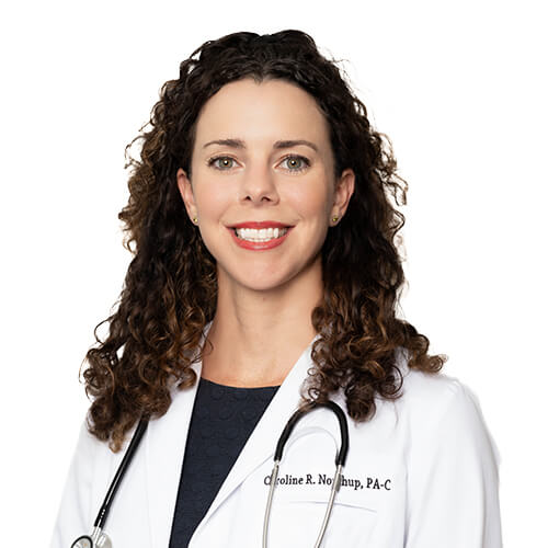 A headshot of Caroline Northrup, PA-C. She has curly brown hair and is wearing a blue shirt with a white coat and a stethoscope around her neck.