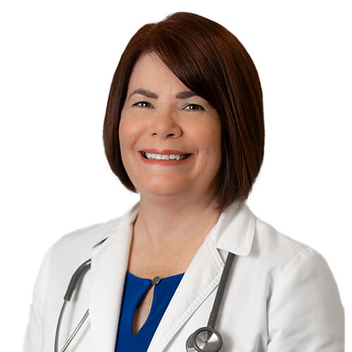 A headshot of Kathleen Davis, MSN, AGNP – C. She has short brown hair and is wearing a white lab coat over a blue shirt with a stethoscope draped around her neck.