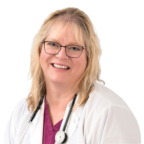 A headshot of Shelly Hamilton, APRN. She has blonde hair and glasses and is wearing a white coat with a stethoscope around her neck.